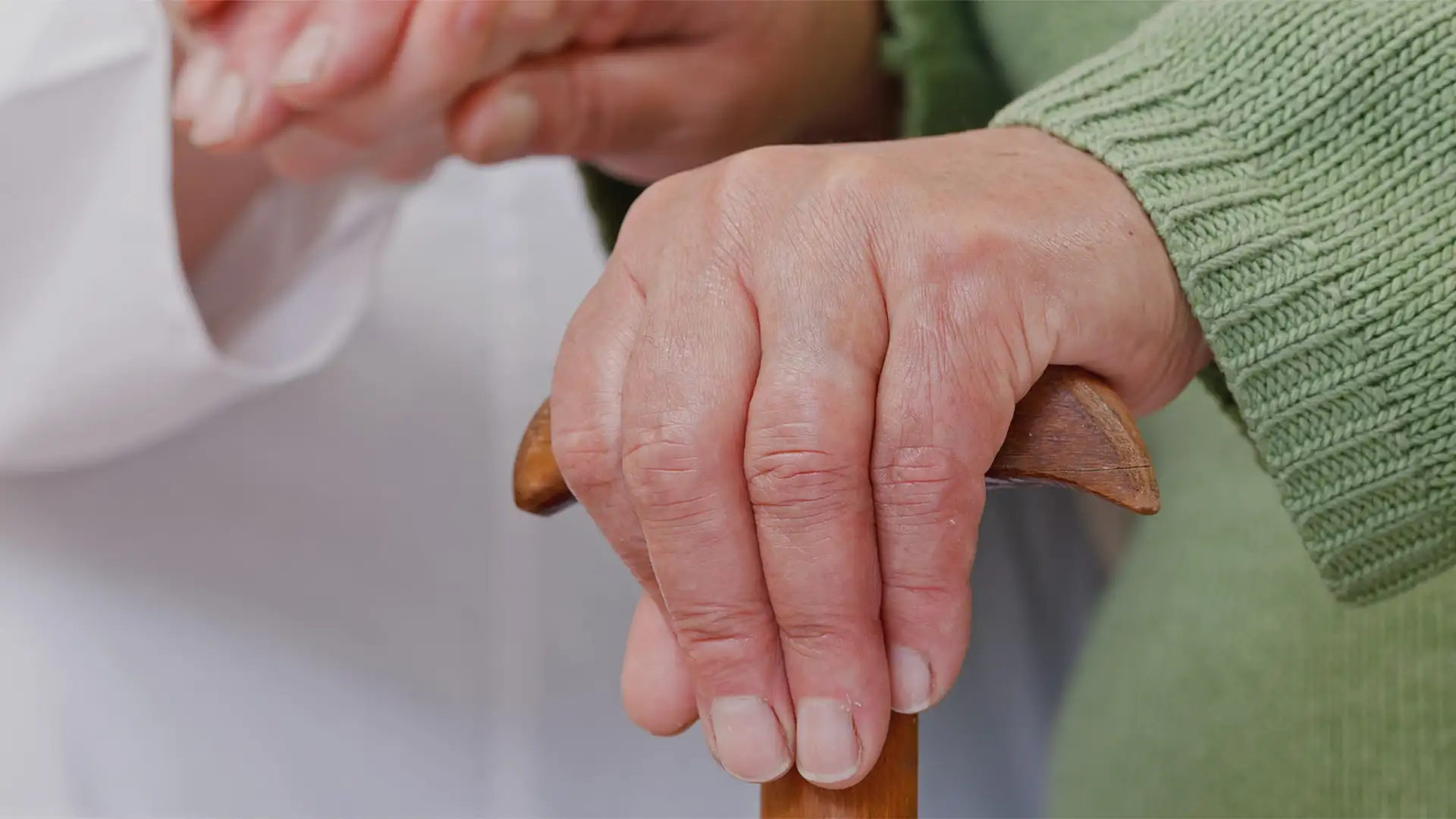 Elderly hands on a walking sitck